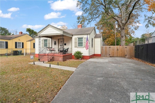 bungalow-style home with a front yard and a porch