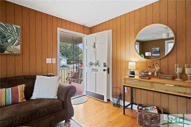 interior space featuring light hardwood / wood-style floors and wooden walls