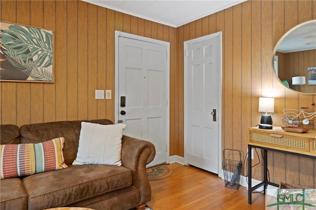 living room featuring crown molding and light hardwood / wood-style floors