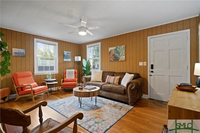 living room featuring ceiling fan and light hardwood / wood-style floors