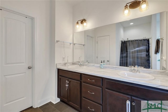 bathroom featuring tile patterned floors, vanity, and walk in shower