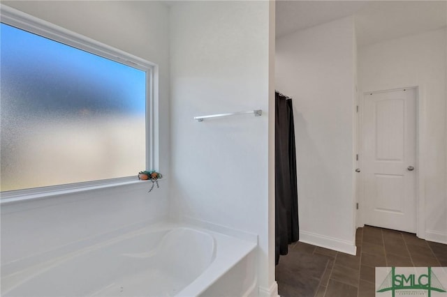 bathroom featuring a tub to relax in and tile patterned floors