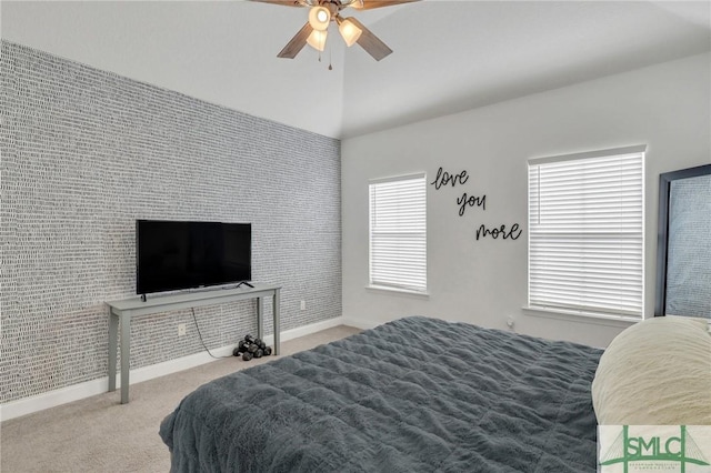 carpeted bedroom with ceiling fan and lofted ceiling