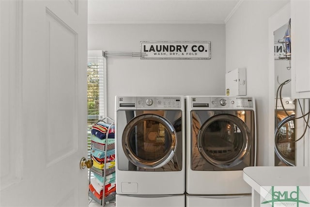 laundry area with washer and dryer and crown molding