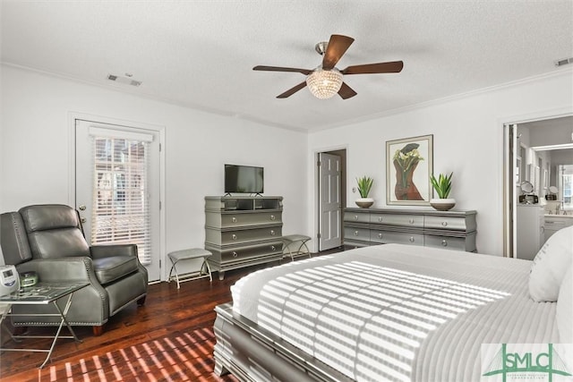 bedroom with dark hardwood / wood-style flooring, a textured ceiling, ensuite bath, and ceiling fan