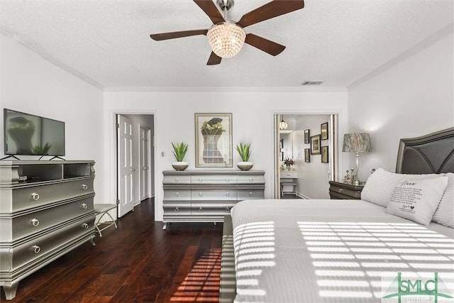 bedroom featuring ceiling fan, dark hardwood / wood-style floors, ensuite bathroom, a textured ceiling, and ornamental molding