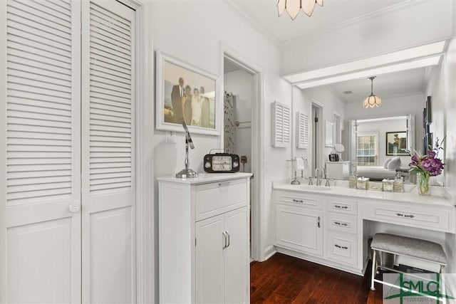 bathroom featuring vanity, hardwood / wood-style flooring, and crown molding