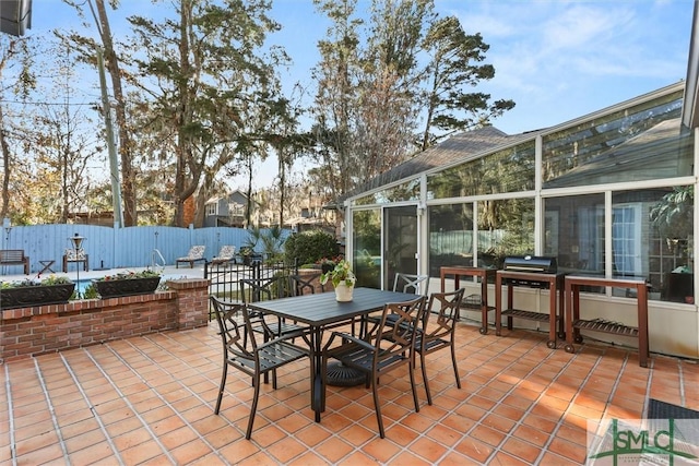 view of patio / terrace featuring area for grilling and a sunroom