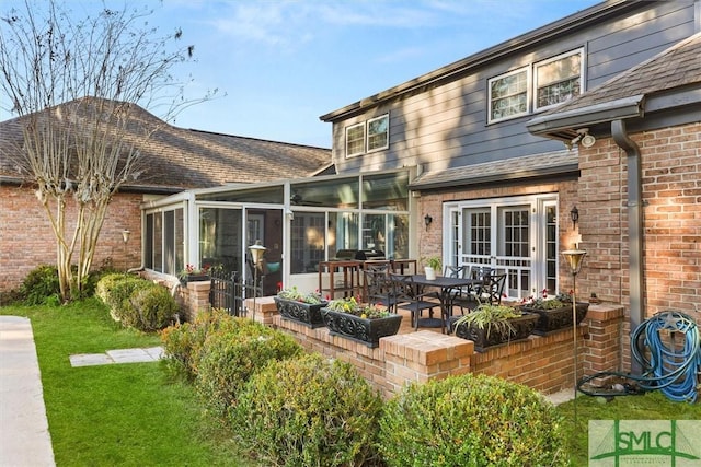 back of house with a patio area and a sunroom