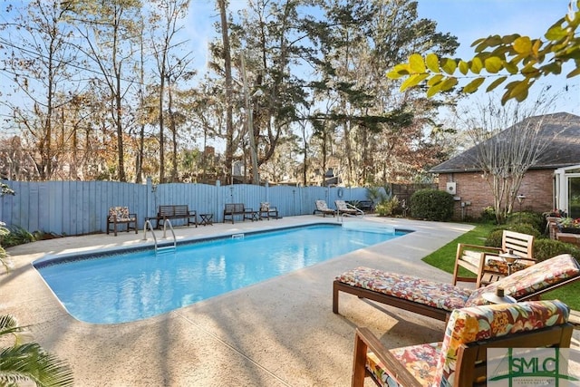 view of swimming pool with a patio area