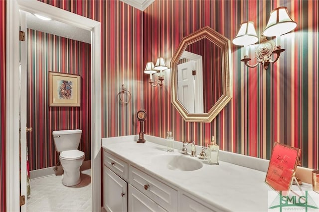 bathroom featuring vanity, ornamental molding, and toilet