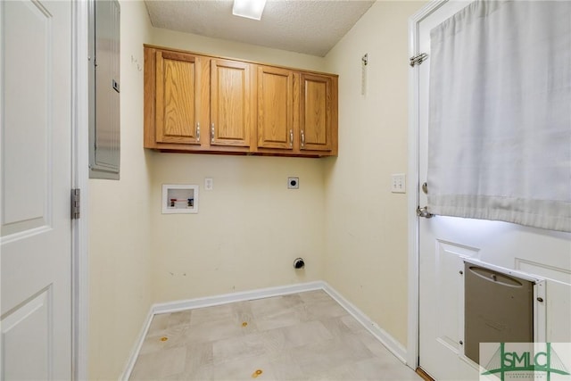 washroom with washer hookup, hookup for an electric dryer, cabinets, and a textured ceiling