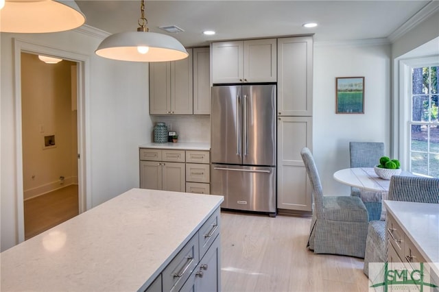 kitchen featuring gray cabinetry, crown molding, light hardwood / wood-style flooring, stainless steel fridge, and decorative light fixtures