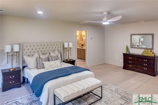 bedroom with ceiling fan, light hardwood / wood-style flooring, and ensuite bath