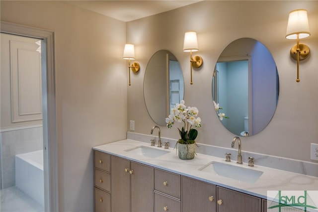 bathroom featuring a bath and vanity