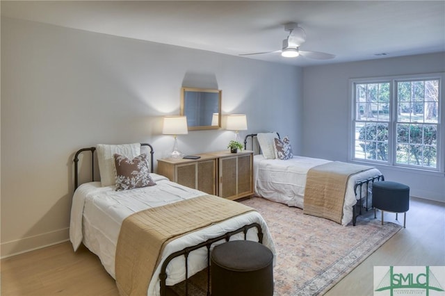 bedroom with ceiling fan and light wood-type flooring