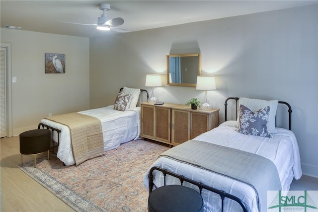 bedroom with ceiling fan and light hardwood / wood-style floors