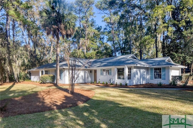 ranch-style home featuring a garage and a front lawn