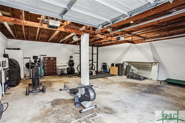 garage with white fridge and a garage door opener