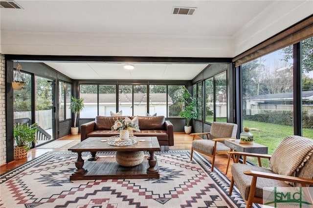 sunroom / solarium featuring a healthy amount of sunlight and vaulted ceiling