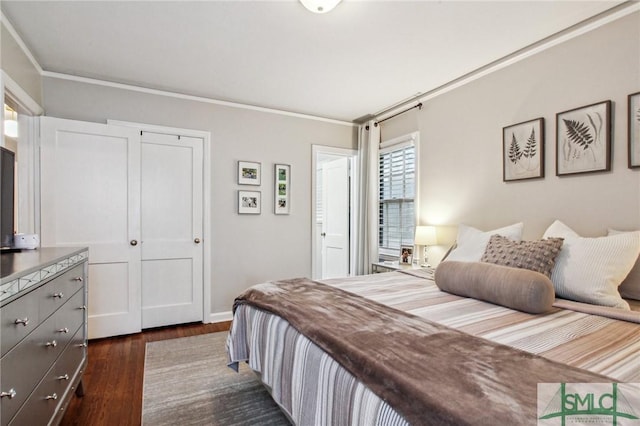 bedroom with dark hardwood / wood-style flooring, a closet, and crown molding