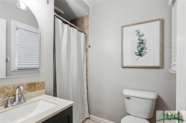 bathroom with vanity, toilet, and walk in shower