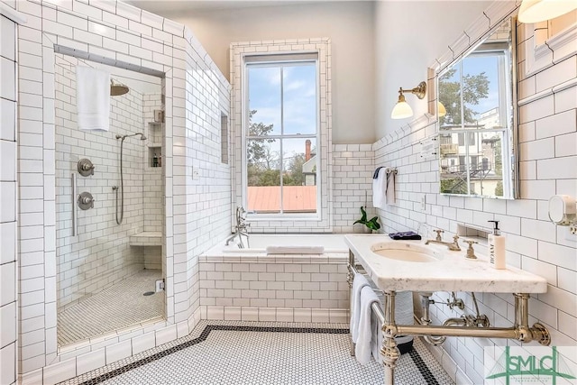 bathroom with tile patterned floors, a wealth of natural light, sink, and shower with separate bathtub