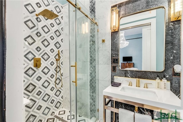 bathroom featuring vanity, a shower with door, and tile walls