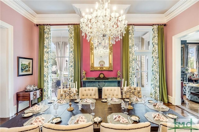 dining area featuring hardwood / wood-style flooring, a healthy amount of sunlight, crown molding, and an inviting chandelier