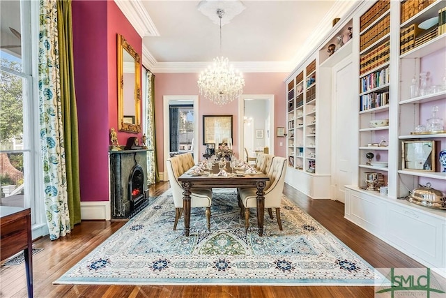 dining area with a chandelier, dark hardwood / wood-style flooring, built in features, and ornamental molding