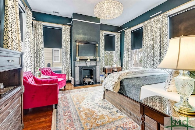 bedroom featuring hardwood / wood-style flooring and an inviting chandelier