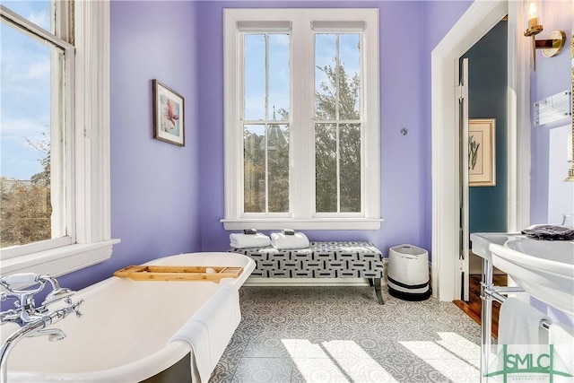 bathroom featuring a bath, tile patterned floors, and a wealth of natural light