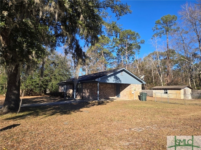 view of side of home with a lawn