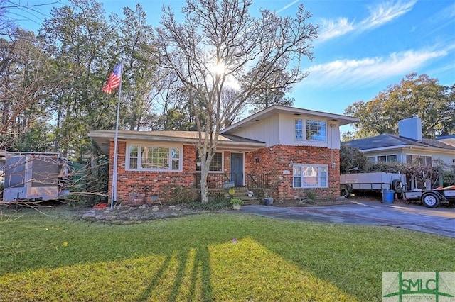 tri-level home with a front yard