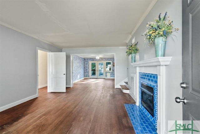 unfurnished living room with a fireplace, french doors, dark hardwood / wood-style flooring, and crown molding