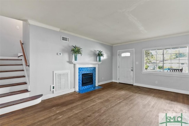 unfurnished living room featuring crown molding and wood-type flooring