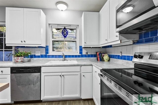 kitchen featuring white cabinetry, sink, appliances with stainless steel finishes, and tasteful backsplash