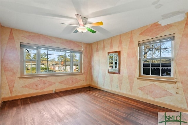 empty room with hardwood / wood-style flooring and ceiling fan