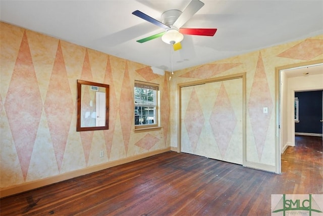 unfurnished bedroom featuring ceiling fan, dark wood-type flooring, and a closet