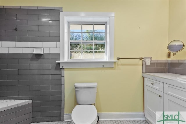 bathroom with tile patterned flooring, vanity, and toilet