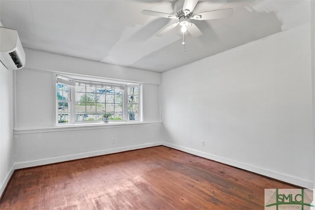 spare room featuring ceiling fan, wood-type flooring, and a wall mounted AC