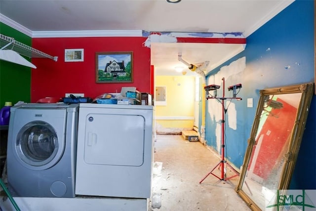 laundry room featuring crown molding and washer and dryer