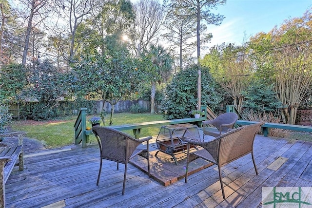 wooden deck featuring a lawn