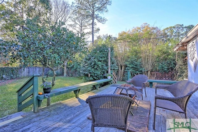 wooden deck featuring a lawn