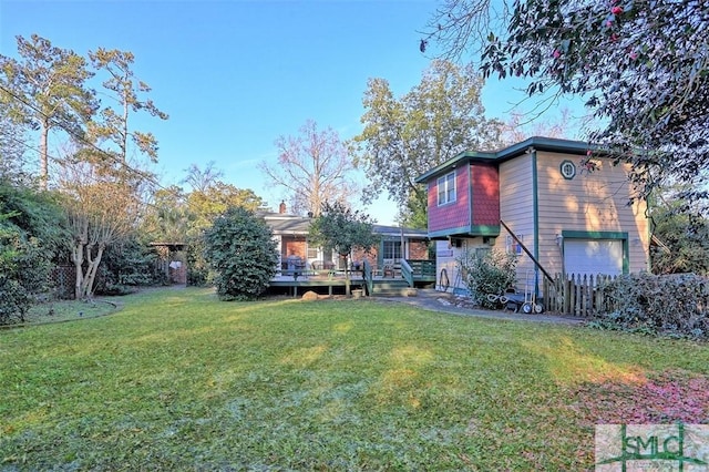 view of yard with a garage and a deck