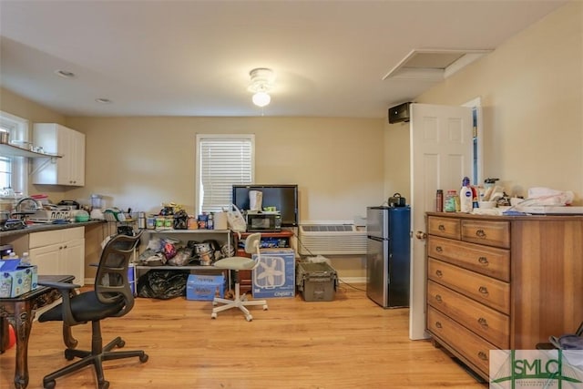 office space with light hardwood / wood-style floors and sink