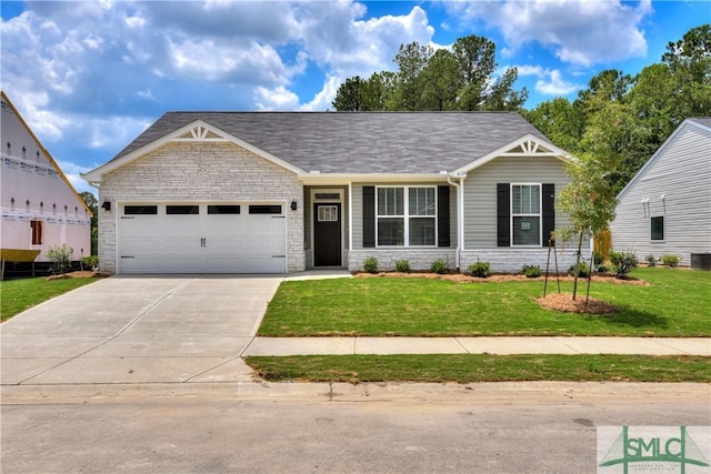 view of front of property with central AC, a front lawn, and a garage