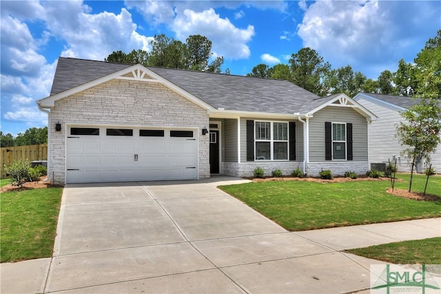 view of front of property with a front yard and a garage