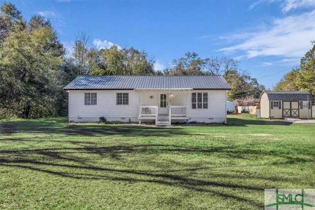 back of house featuring a lawn and a storage unit