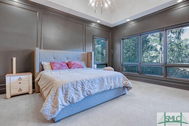 carpeted bedroom featuring an inviting chandelier and crown molding